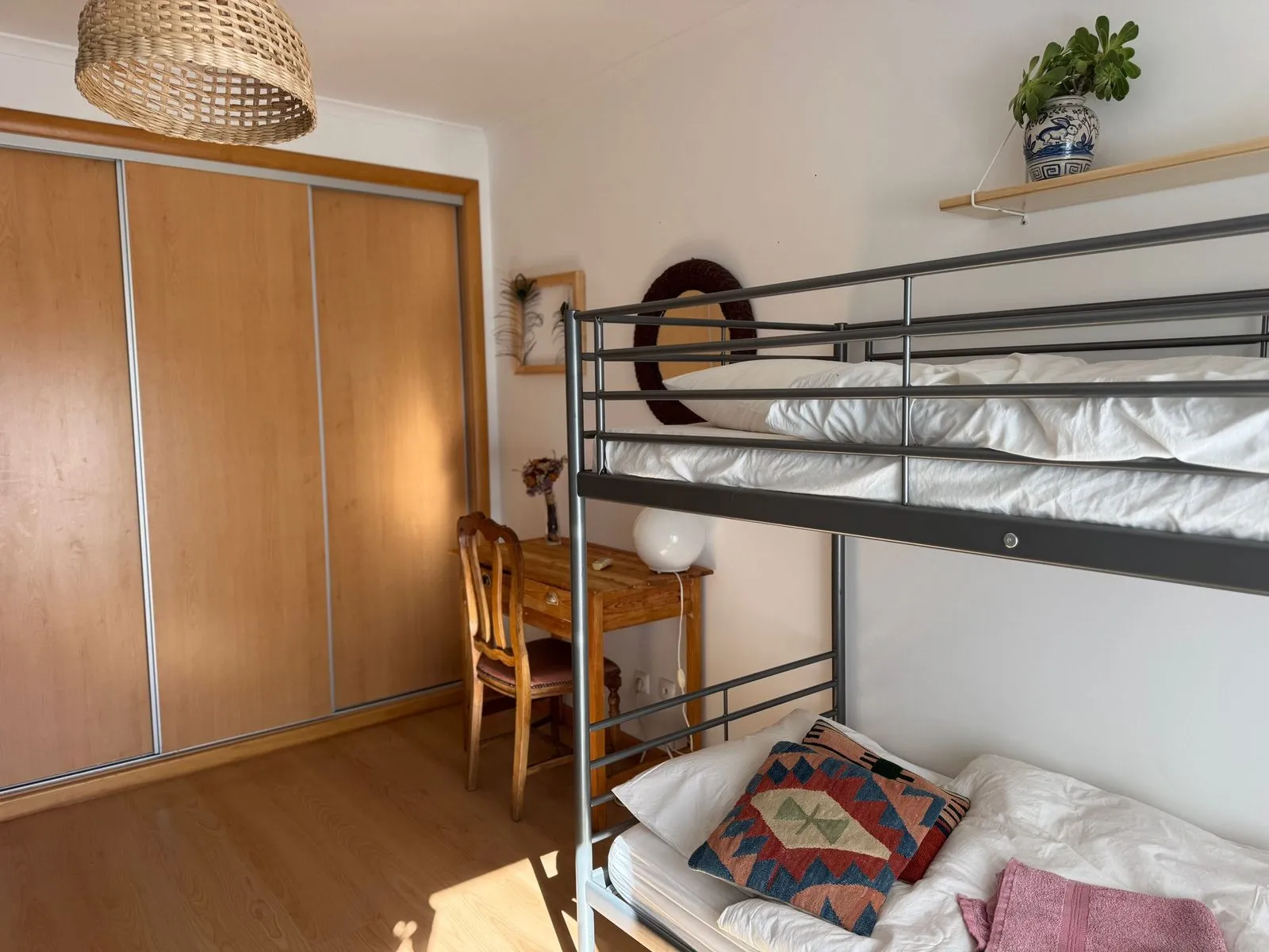 Room with a bunk bed, sofa and wardrobe