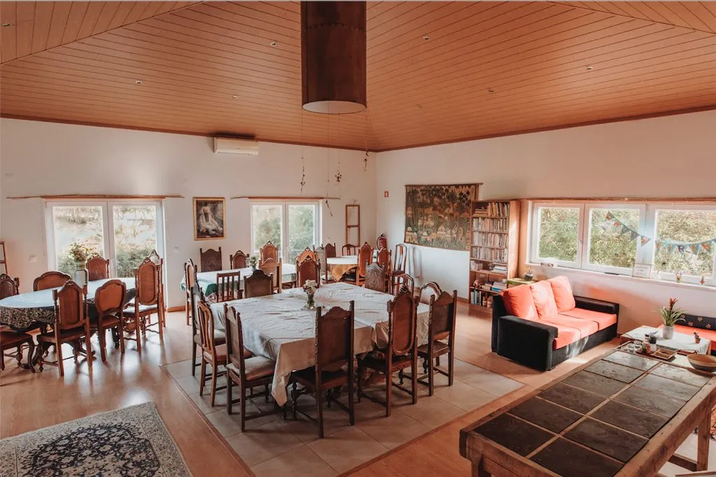 The Ashram lounge with dining tables, sofas and windows onto the garden