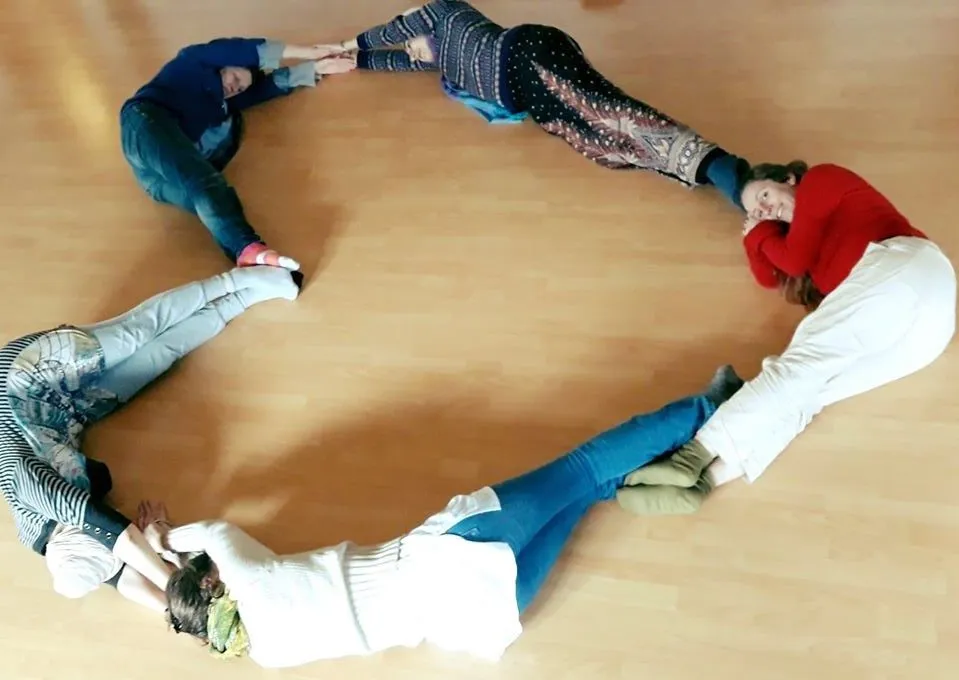 Sevadars lying on the floor forming a heart shape